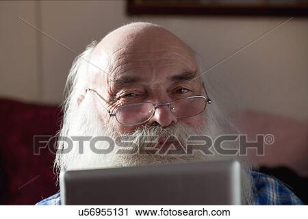 Stock Image - Senior man using digital tablet. Fotosearch