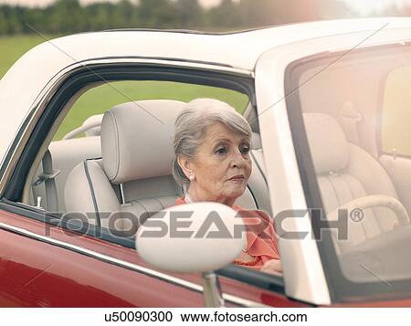Senior woman driving red convertible View Large Photo Image Stock Image - Senior woman driving red convertible. Fotosearch