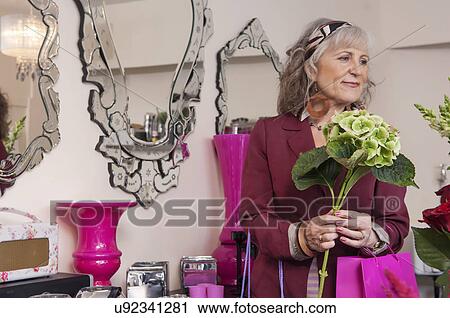 Senior woman with flowers in florist shop View Large Photo Image Stock Image - Senior woman with flowers in florist shop. Fotosearch