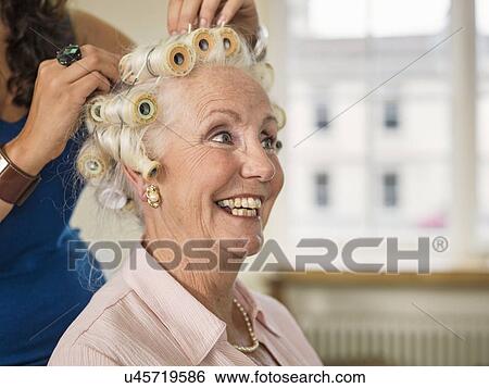 Senior woman with rollers at hairdressers View Large Photo Image Stock Photograph - Senior woman with rollers at hairdressers. Fotosearch