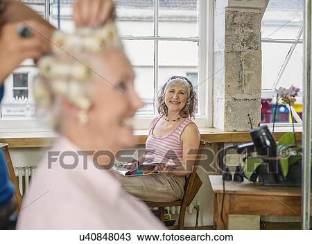 Stock Image - Senior women at hairdressers. Fotosearch