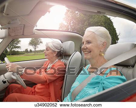 Senior women driving in convertible View Large Photo Image Stock Image - Senior women driving in convertible. Fotosearch