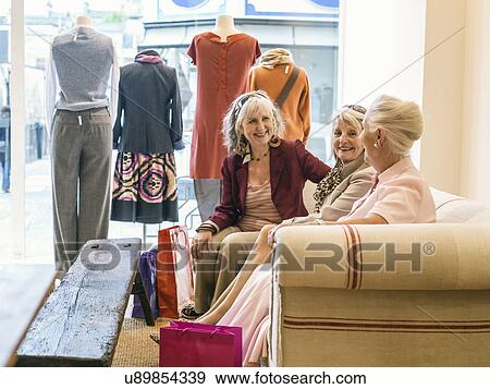 Senior women taking a break in boutique View Large Photo Image Stock Photo - Senior women taking a break in boutique. Fotosearch