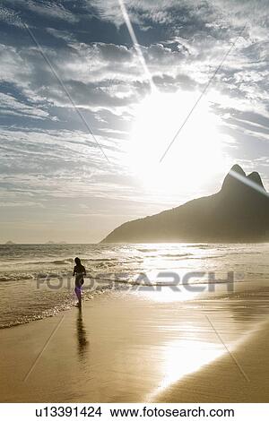 Picture - Silhouette of woman on Ipanema beach, Rio De Janeiro, Brazil. Fotosearch