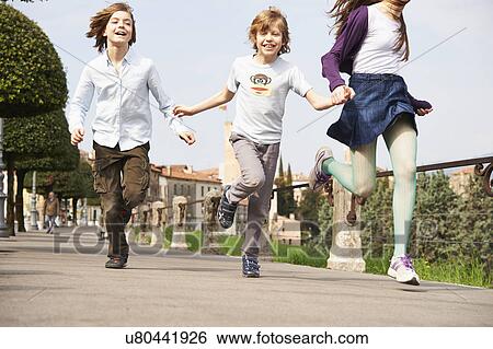 Sister and younger brothers running through park, Province of Venice, Italy View Large Photo Image Stock Photograph - Sister and younger brothers running through park, Province of Venice, Italy. Fotosearch