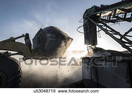 Stock Photo - Steam rising from coal in morning light at surface coal mine. Fotosearch