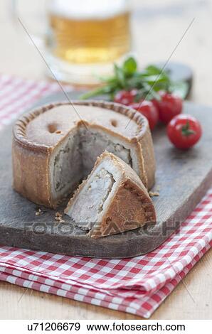 Stock Photo - Still life of melton mowbray pork pie on chopping board. Fotosearch