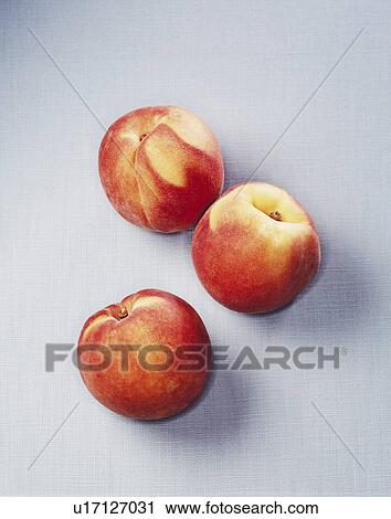 Stock Image - Still life of three peaches. Fotosearch