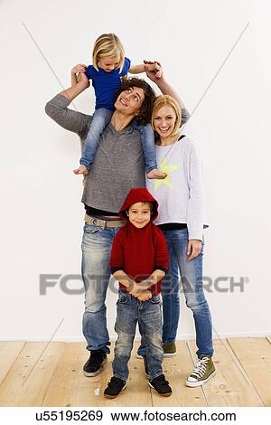 Studio portrait of couple together with son and daughter View Large Photo Image Stock Photo - Studio portrait of couple together with son and daughter. Fotosearch