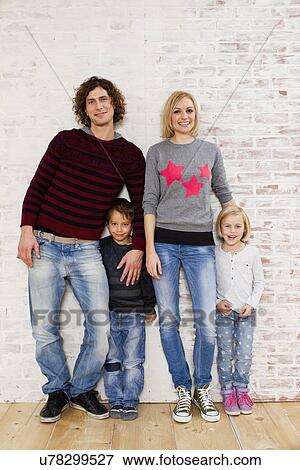 Studio portrait of couple with son and daughter View Large Photo Image Stock Photo - Studio portrait of couple with son and daughter. Fotosearch