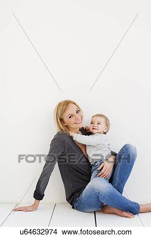 Studio portrait of mother and baby girl View Large Photo Image Picture - Studio portrait of mother and baby girl. Fotosearch