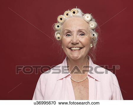 Studio portrait of senior woman in hair rollers View Large Photo Image Stock Image - Studio portrait of senior woman in hair rollers. Fotosearch
