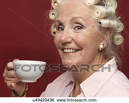 Studio portrait of senior woman in hair rollers with cup of tea View Large Photo Image Stock Photograph - Studio portrait of senior woman in hair rollers with cup of tea. Fotosearch