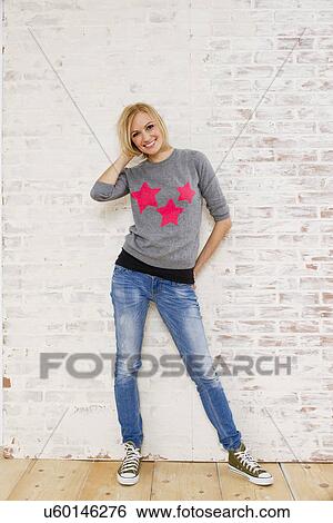Studio portrait of young woman and brick wall View Large Photo Image Stock Photograph - Studio portrait of young woman and brick wall. Fotosearch