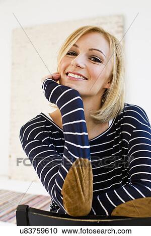 Stock Image - Studio portrait of young woman in stripes. Fotosearch