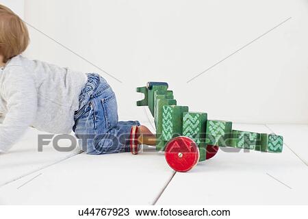 Studio shot of baby girl and wheeled toy View Large Photo Image Stock Image - Studio shot of baby girl and wheeled toy. Fotosearch