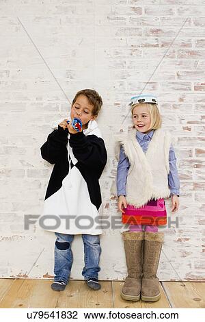 Studio shot of brother and sister in oversize clothes View Large Photo Image Stock Image - Studio shot of brother and sister in oversize clothes. Fotosearch