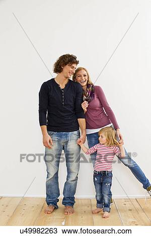 Studio shot of couple holding hands with young daughter View Large Photo Image Stock Image - Studio shot of couple holding hands with young daughter. Fotosearch