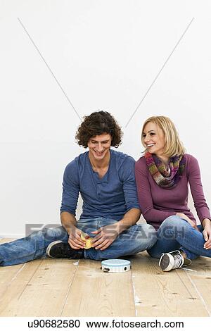 Studio shot of couple sitting on floor with toys View Large Photo Image Stock Image - Studio shot of couple sitting on floor with toys. Fotosearch