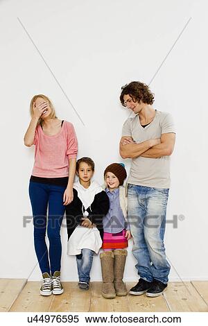 Studio shot of couple with son and daughter in oversize clothes View Large Photo Image Stock Photography - Studio shot of couple with son and daughter in oversize clothes. Fotosearch