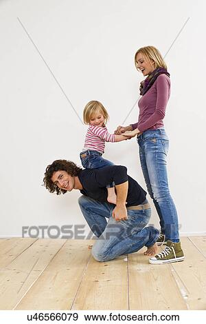 Studio shot of couple with young daughter View Large Photo Image Stock Photo - Studio shot of couple with young daughter. Fotosearch