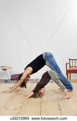 Studio shot of father and daughter bending over on floor View Large Photo Image Stock Photography - Studio shot of father and daughter bending over on floor. Fotosearch