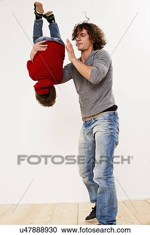 Studio shot of father turning over son in mid air View Large Photo Image Stock Image - Studio shot of father turning over son in mid air. Fotosearch