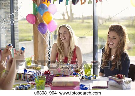 Teenage girl and friends enjoying birthday party View Large Photo Image Picture - Teenage girl and friends enjoying birthday party. Fotosearch