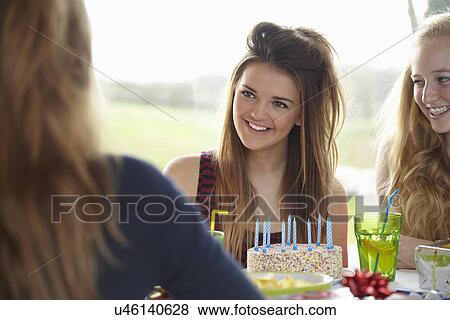 Stock Photo - Teenage girl and friends enjoying birthday. Fotosearch