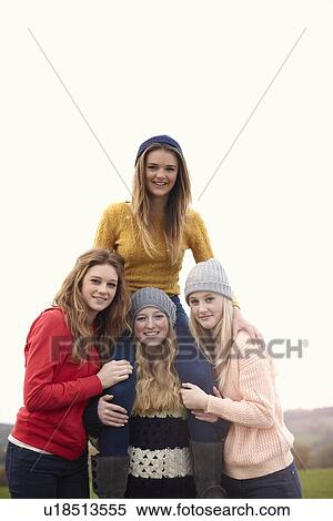 Teenage girl getting shoulder ride from friends View Large Photo Image Stock Photography - Teenage girl getting shoulder ride from friends. Fotosearch