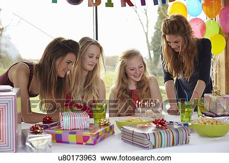 Teenage girl sharing birthday cake with friends View Large Photo Image Stock Image - Teenage girl sharing birthday cake with friends. Fotosearch