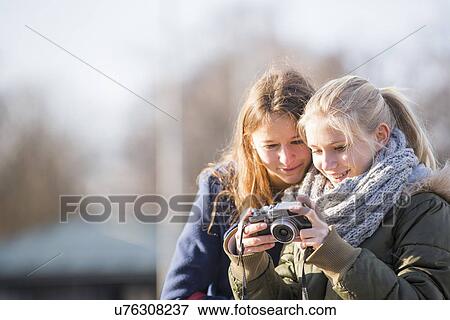 Teenage girls using camera View Large Photo Image Stock Photo - Teenage girls using camera. Fotosearch