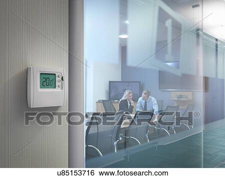 Thermostat outside conference room with office workers in meeting View Large Photo Image Stock Photograph - Thermostat outside conference room with office workers in meeting. Fotosearch