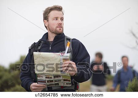 Three men hiking with backpacks and map View Large Photo Image Stock Photography - Three men hiking with backpacks and map. Fotosearch