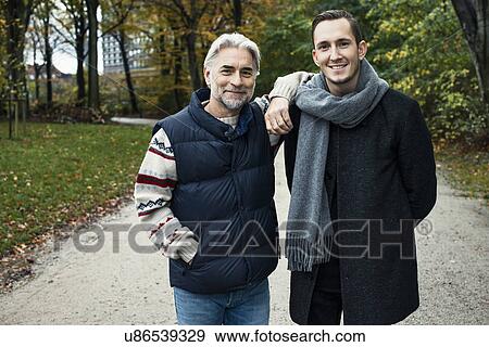 Stock Photo - Two male friends posing in woods. Fotosearch