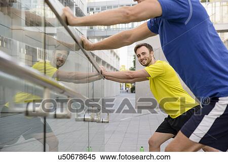 Two men leaning and stretching View Large Photo Image Stock Photography - Two men leaning and stretching. Fotosearch