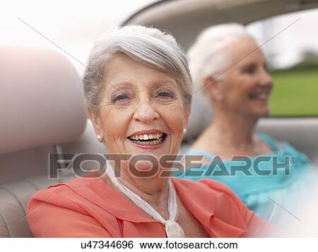 Two senior women driving in convertible View Large Photo Image Stock Photograph - Two senior women driving in convertible. Fotosearch