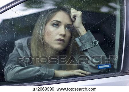 Unhappy young woman waiting in car View Large Photo Image Stock Image - Unhappy young woman waiting in car. Fotosearch