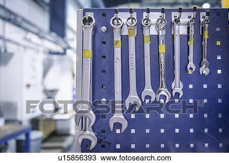 Variety of spanners hanging from workstation rack in factory View Large Photo Image Stock Image - Variety of spanners hanging from workstation rack in factory. Fotosearch