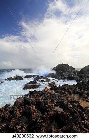 Stock Image - Waves splashing on rocks, Aruba, Caribbean. Fotosearch