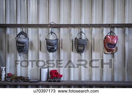 Stock Image - Welding masks in engineering workshop. Fotosearch