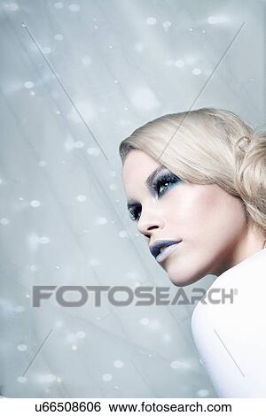 Stock Photograph - Woman against glittery background. Fotosearch