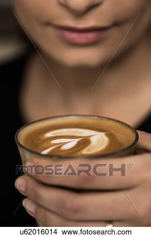 Woman holding cup of coffee View Large Photo Image Picture - Woman holding cup of coffee. Fotosearch