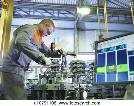 Worker assembling and testing clutches on rig in factory View Large Photo Image Stock Photograph - Worker assembling and testing clutches on rig in factory. Fotosearch