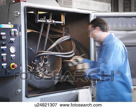 Worker shot blasting springs in laboratory View Large Photo Image Stock Photo - Worker shot blasting springs in laboratory. Fotosearch