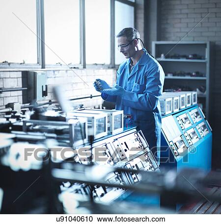 Stock Image - Worker testing spring in laboratory. Fotosearch