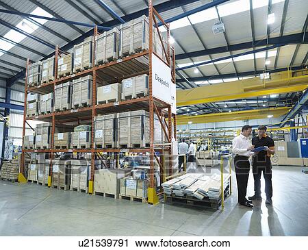 Workers in discussion in factory View Large Photo Image Stock Image - Workers in discussion in factory. Fotosearch