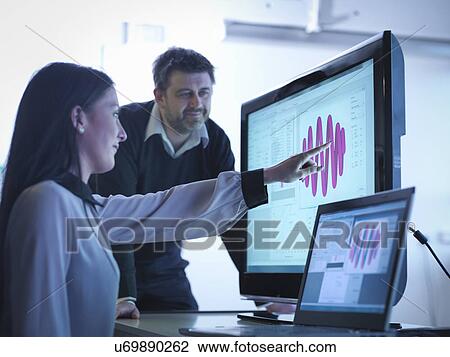 Workers using software to calibrate springs in office View Large Photo Image Stock Image - Workers using software to calibrate springs in office. Fotosearch