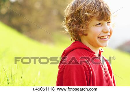 Stock Photo - Young boy in grassy field. Fotosearch