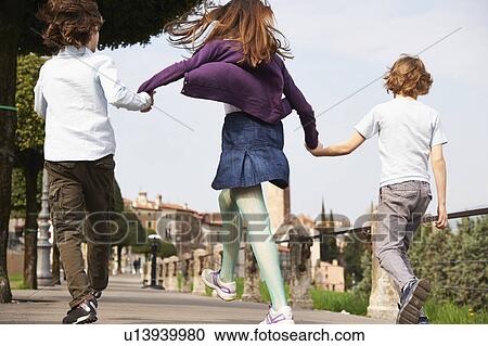 Young boys and older sister marching through park, Province of Venice, Italy View Large Photo Image Stock Image - Young boys and older sister marching through park, Province of Venice, Italy. Fotosearch